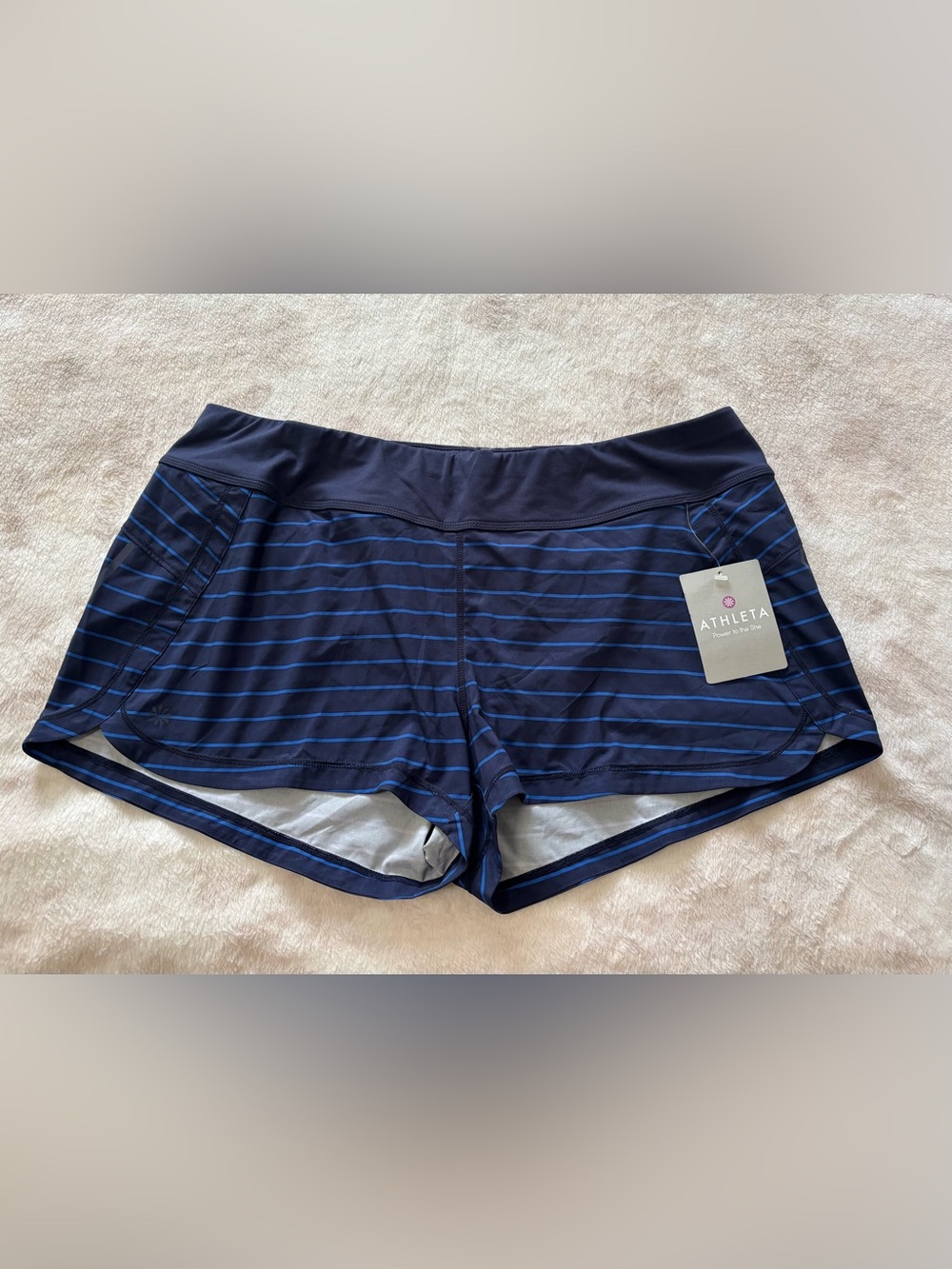 Athleta running shorts featuring thin blue horizontal stripes Size XL